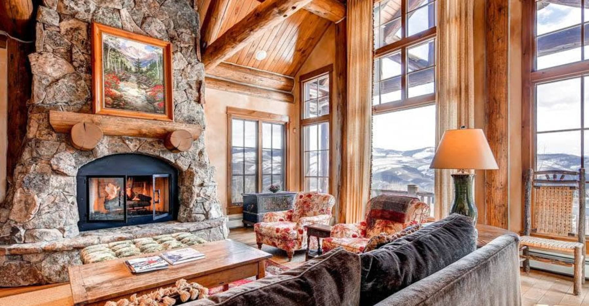 Cozy living room featuring a stone fireplace and comfortable couches, perfect for relaxation and gatherings.