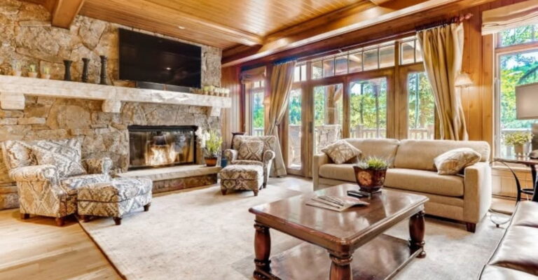 Stylish living room showcasing a charming stone fireplace and soft couches, ideal for family time and cozy evenings.