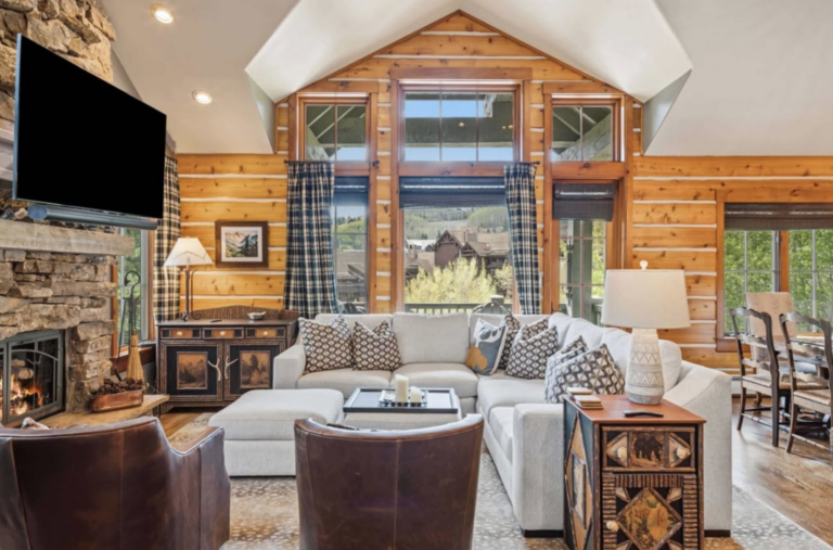 inside of a ski cabin with a couch and big window